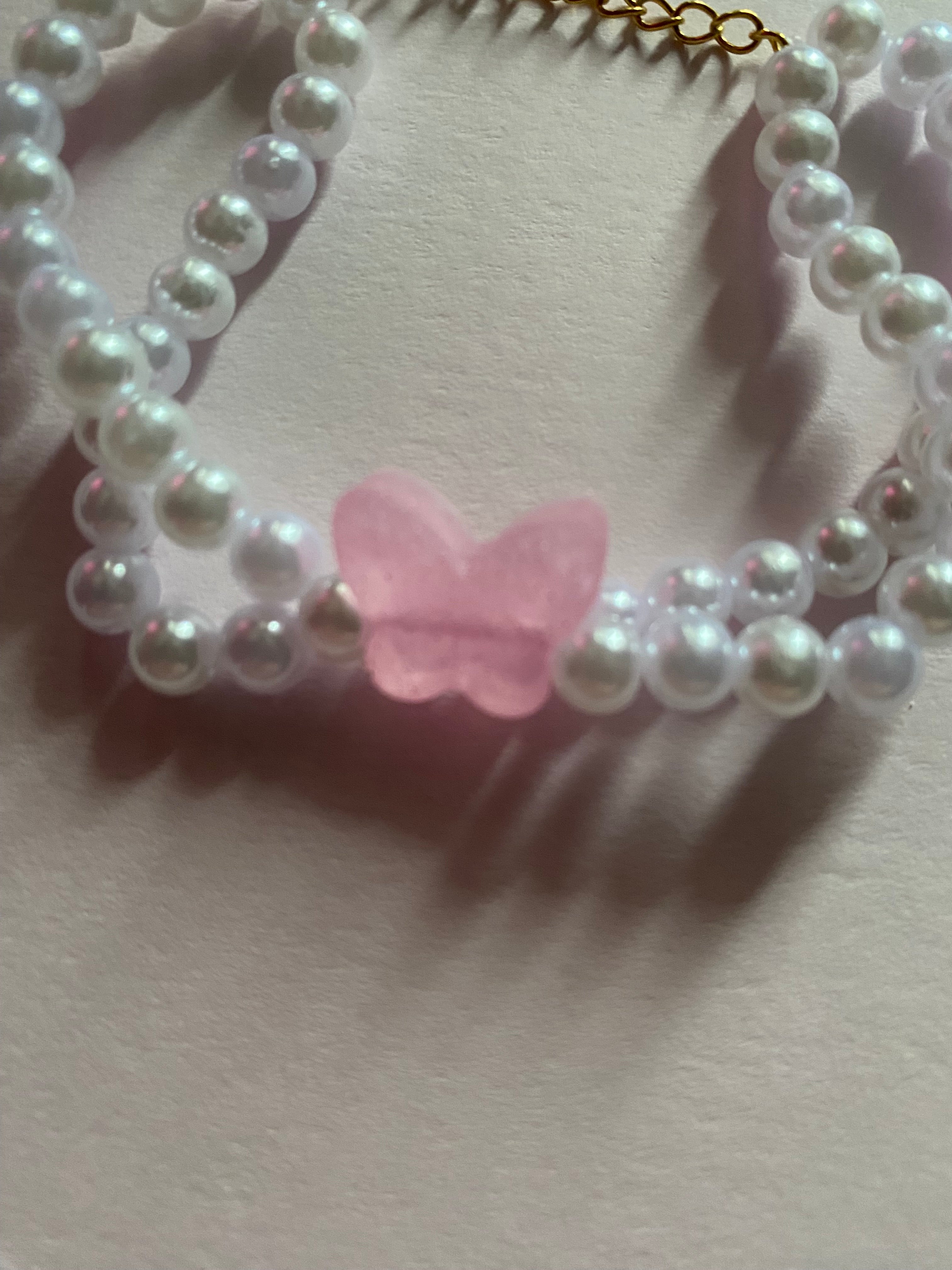 Pink butterfly and pearl bracelet.