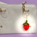 Strawberry pipe cleaner keychain.