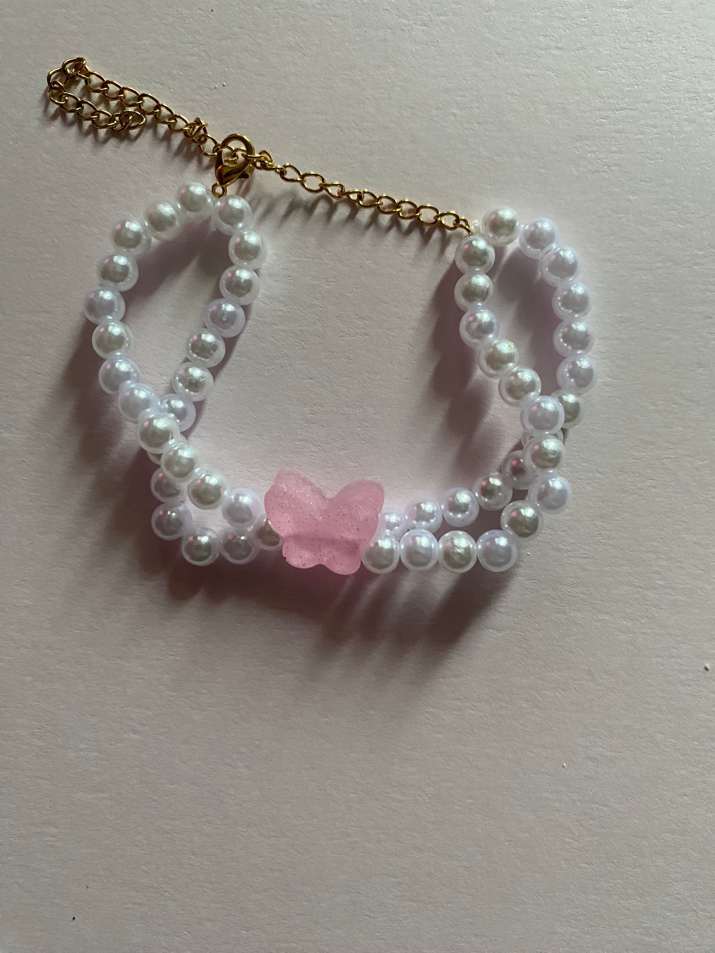 Pink butterfly and pearl bracelet.