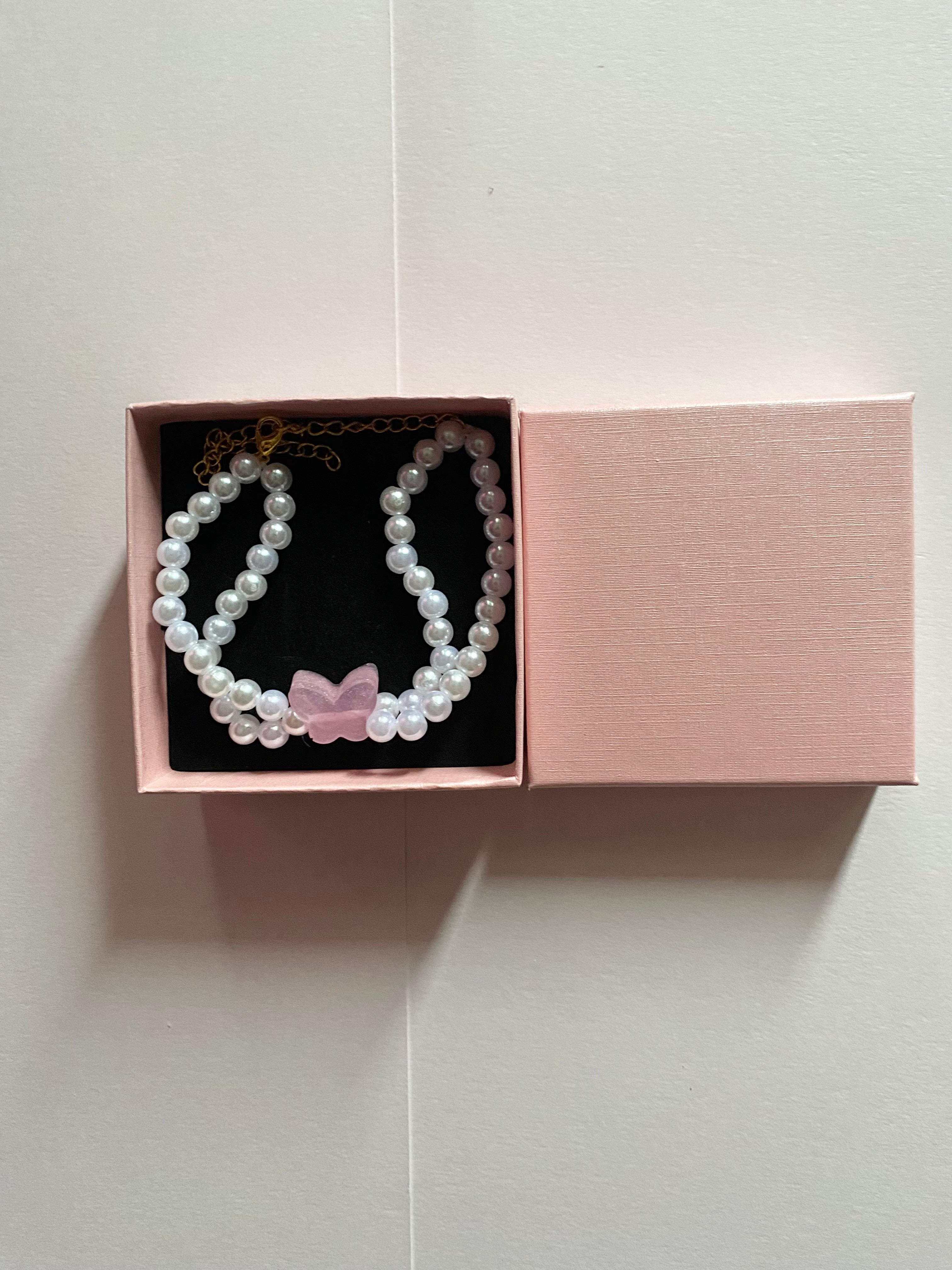 Pink butterfly and pearl bracelet.